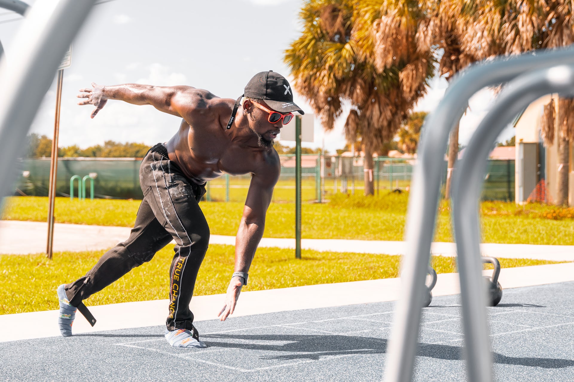 The coach stretching at an outdoor training facility.